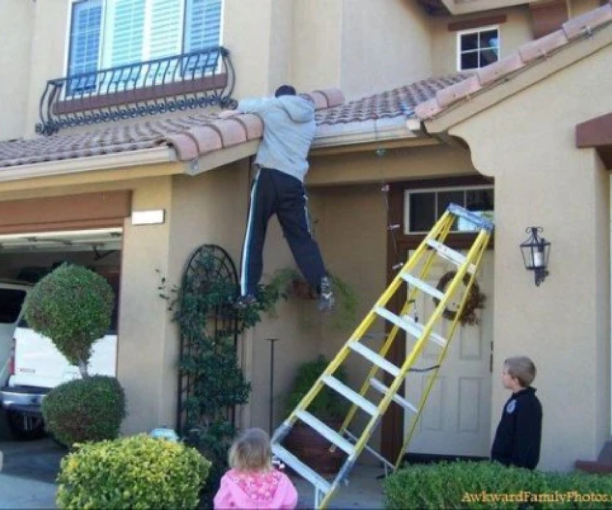 A person about to fall while using the ladder without any safety device