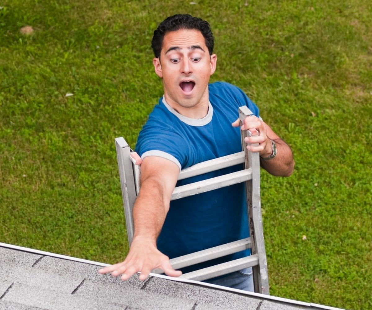 A person reaching out the ceiling about to fall down on a ladder