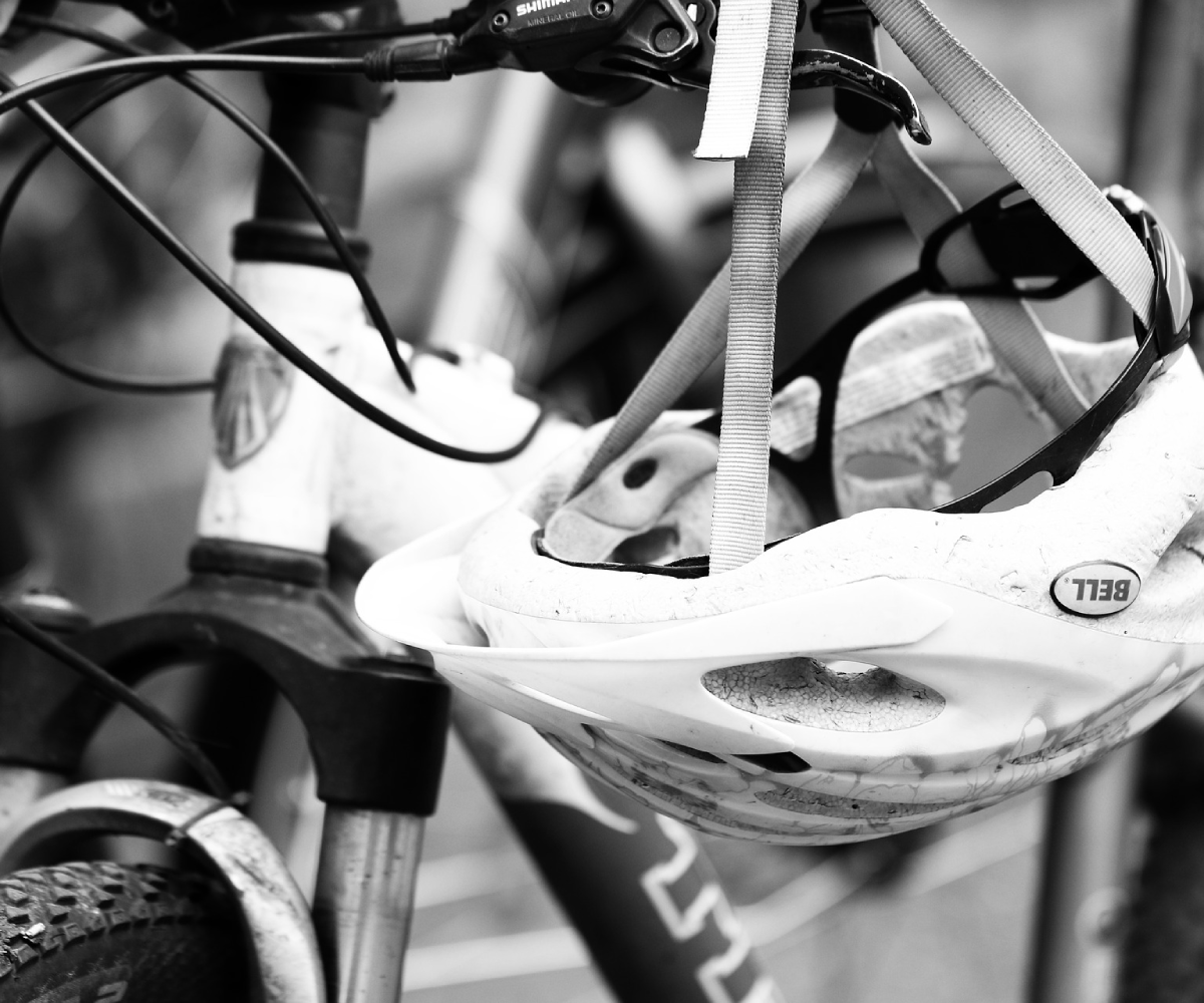 A black and white photo of a bike and a bike helmet