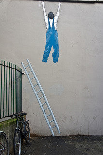 A drawing of person hanging on the ceiling with the ladder slipping off