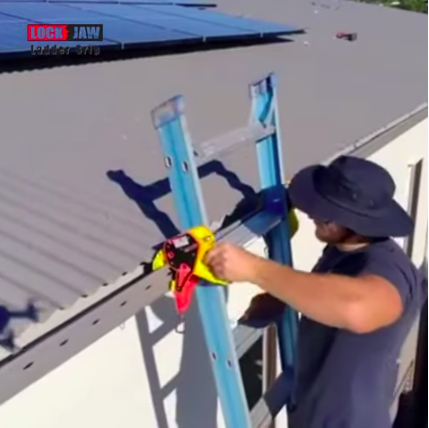 A person attaching lock jaw ladder grip device into the grey gutter