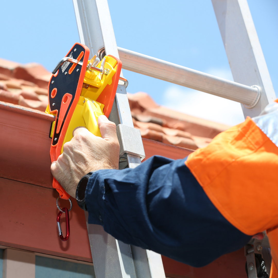 a person accessing roof using the ladder clamp by lock jaw ladder grip