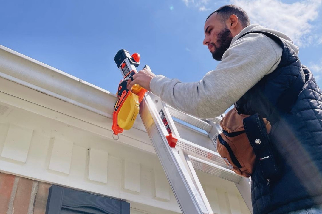 A man accessing the roof using the best ladder stabilizer in Australia from Lock Jaw Ladder Grip